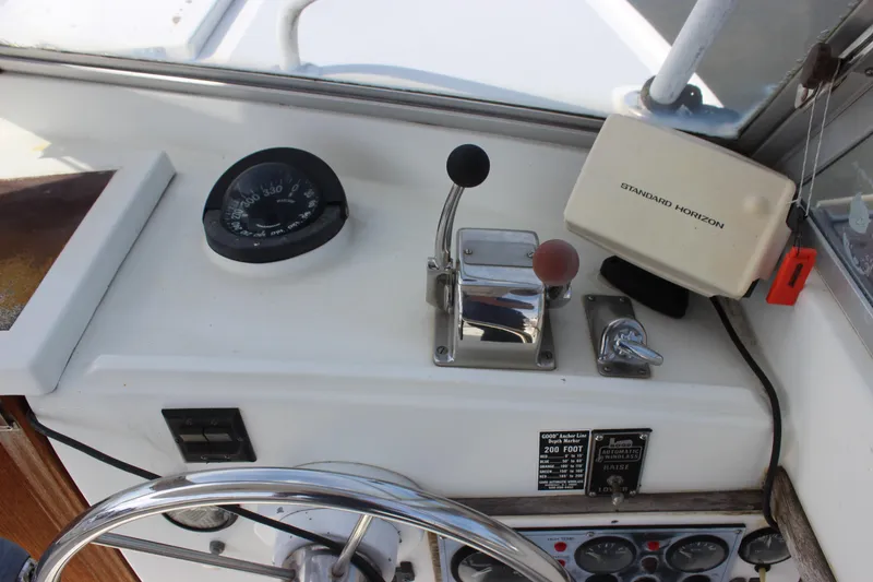 Slide: The Image of 1979 Tripp Angler 22 Flush Deck Cuddy helm with compass and Standard Horizon device. - 12