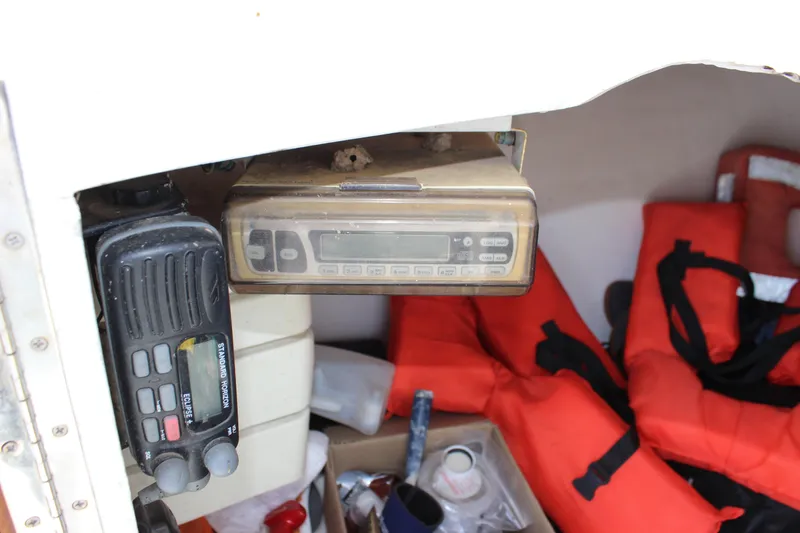 Slide: The Image of Interior of 1979 Tripp Angler boat with radio equipment and life jackets. - 15
