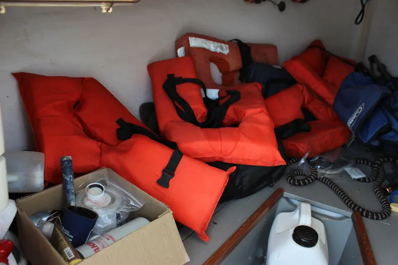 Slide: The Image of Life jackets and supplies inside a 1979 Tripp Angler 22 Flush Deck Cuddy boat. - 17