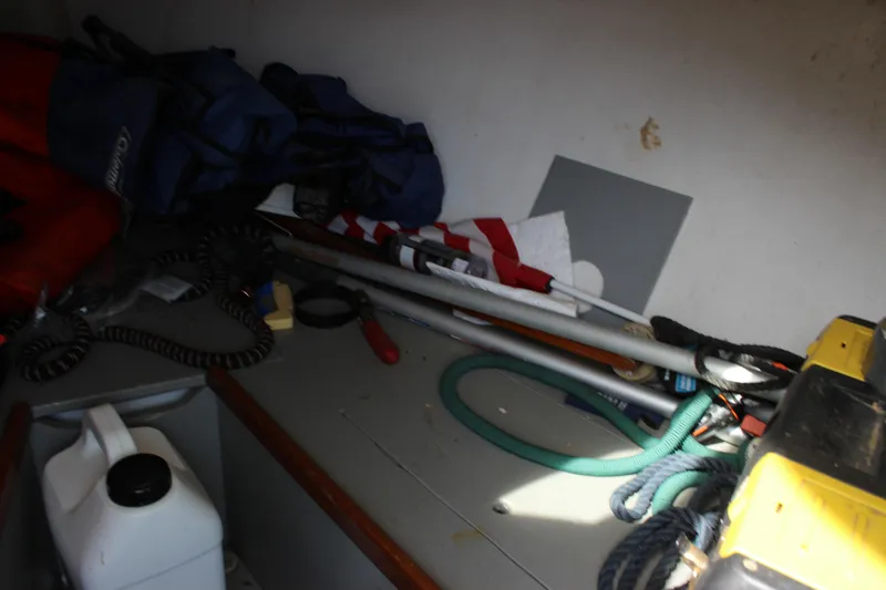 Slide: The Image of Interior of 1979 Tripp Angler 22 Flush Deck Cuddy with boating equipment and supplies. - 18