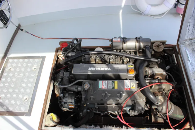 Slide: The Image of Engine compartment of a 1979 Tripp Angler 22 Flush Deck Cuddy boat, featuring a Yanmar engine. - 22