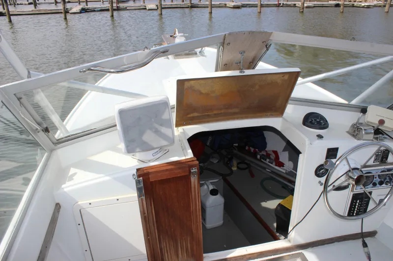 Slide: The Image of 1979 Tripp Angler 22 Flush Deck Cuddy boat interior with steering wheel and dashboard. - 23