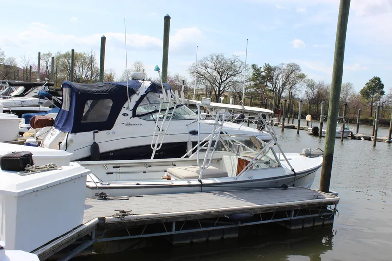 Slide: The Image of 1979 Tripp Angler 22 Flush Deck Cuddy docked at a marina. - 3