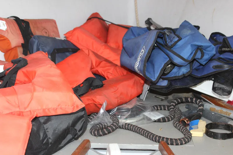 Slide: The Image of Life jackets and gear inside a 1979 Tripp Angler 22 Flush Deck Cuddy boat. - 30
