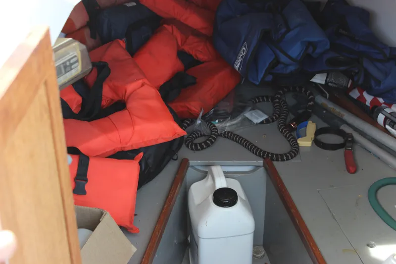 Slide: The Image of Interior of 1979 Tripp Angler boat with life jackets and boating equipment. - 31