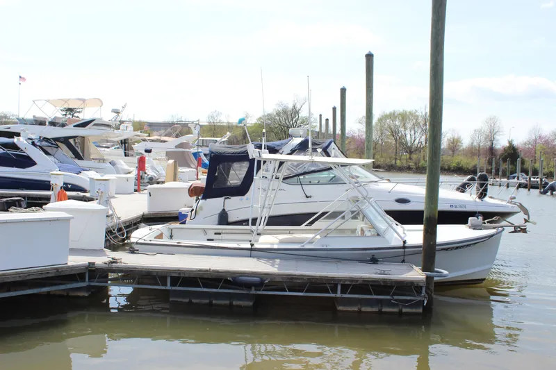 Slide: The Image of 1979 Tripp Angler 22 Flush Deck Cuddy docked at a marina. - 4