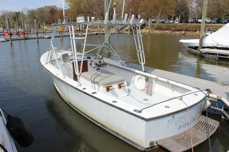 Slide: The Image of 1979 Tripp Angler 22 Flush Deck Cuddy boat docked at marina. - 5