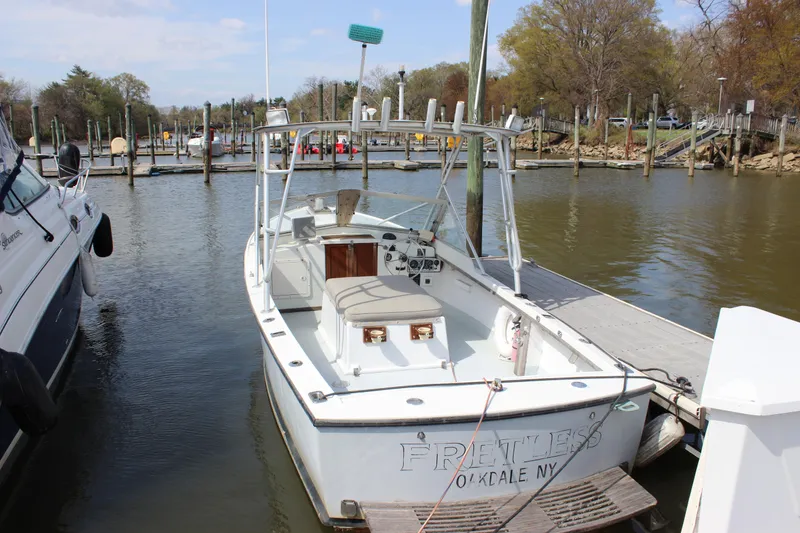 Slide: The Image of 1979 Tripp Angler 22 Flush Deck Cuddy boat docked at a marina. - 6