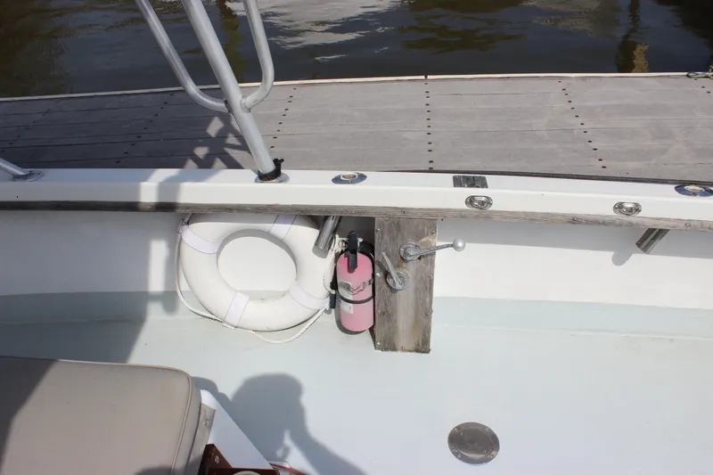 Slide: The Image of 1979 Tripp Angler 22 Flush Deck Cuddy boat interior with life preserver and fire extinguisher. - 7