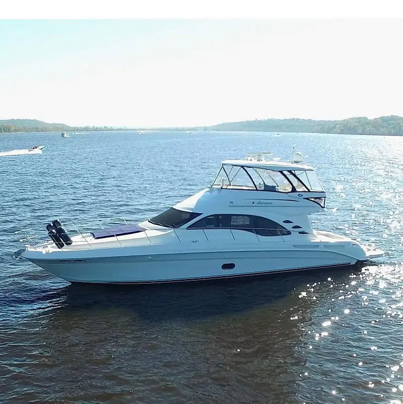 The Image of 2007 Sea Ray 58 Sedan Bridge yacht cruising on a serene lake. - 0
