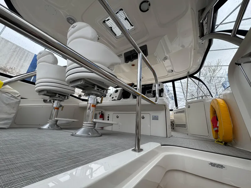 Slide: The Image of 2007 Sea Ray 58 Sedan Bridge interior with helm chairs and safety equipment. - 13