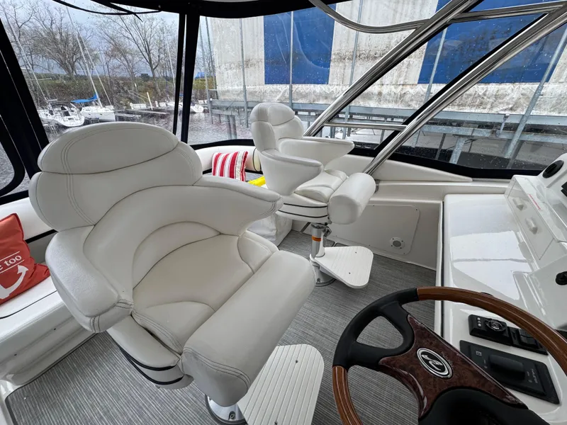Slide: The Image of Luxurious 2007 Sea Ray 58 Sedan Bridge helm with plush white seating and modern controls. - 16