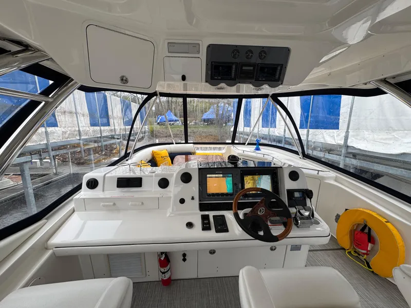Slide: The Image of 2007 Sea Ray 58 Sedan Bridge helm with modern navigation equipment and panoramic windows. - 17