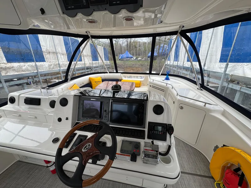 Slide: The Image of 2007 Sea Ray 58 Sedan Bridge helm with modern navigation equipment and panoramic windows. - 20
