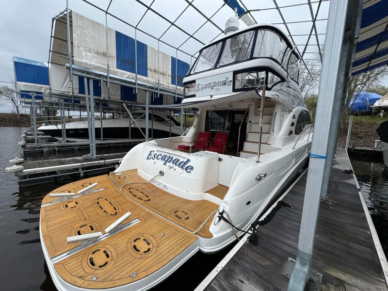 Slide: The Image of 2007 Sea Ray 58 Sedan Bridge yacht docked under a canopy. - 3