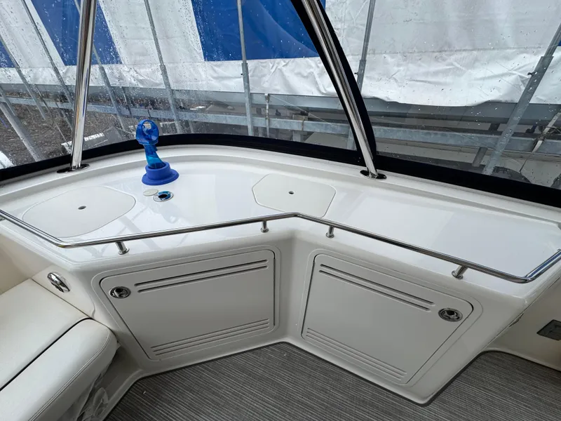 Slide: The Image of 2007 Sea Ray 58 Sedan Bridge interior with sleek white cabinetry and seating. - 30