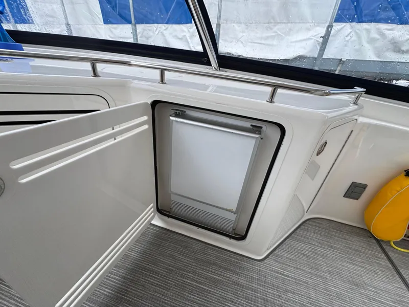 Slide: The Image of 2007 Sea Ray 58 Sedan Bridge interior with open mini fridge and sleek design. - 33