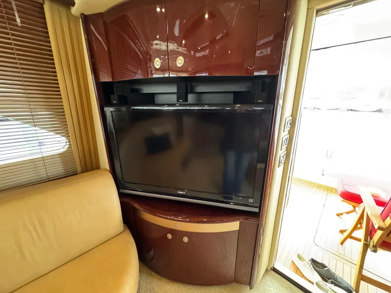 Slide: The Image of Luxurious interior of 2007 Sea Ray 58 Sedan Bridge with TV and wooden cabinetry. - 40