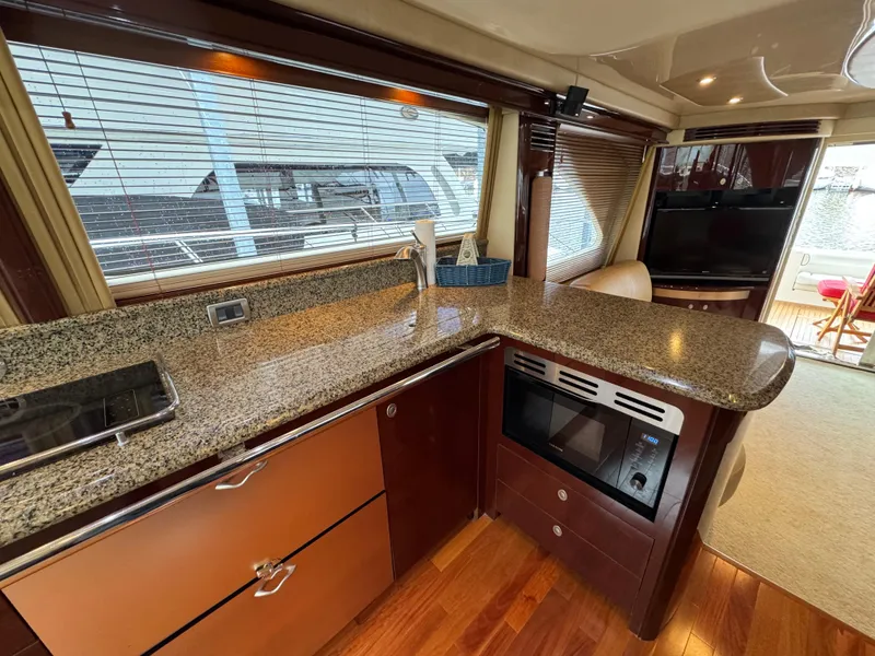 Slide: The Image of Luxurious kitchen interior of 2007 Sea Ray 58 Sedan Bridge yacht with granite countertops. - 44