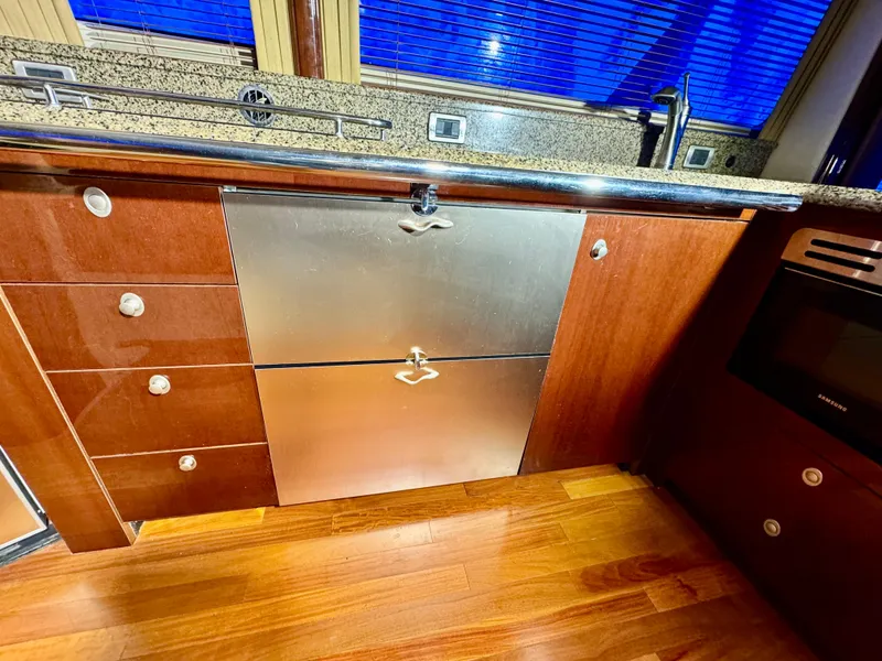 Slide: The Image of Luxurious kitchen interior of 2007 Sea Ray 58 Sedan Bridge yacht with wood flooring. - 46