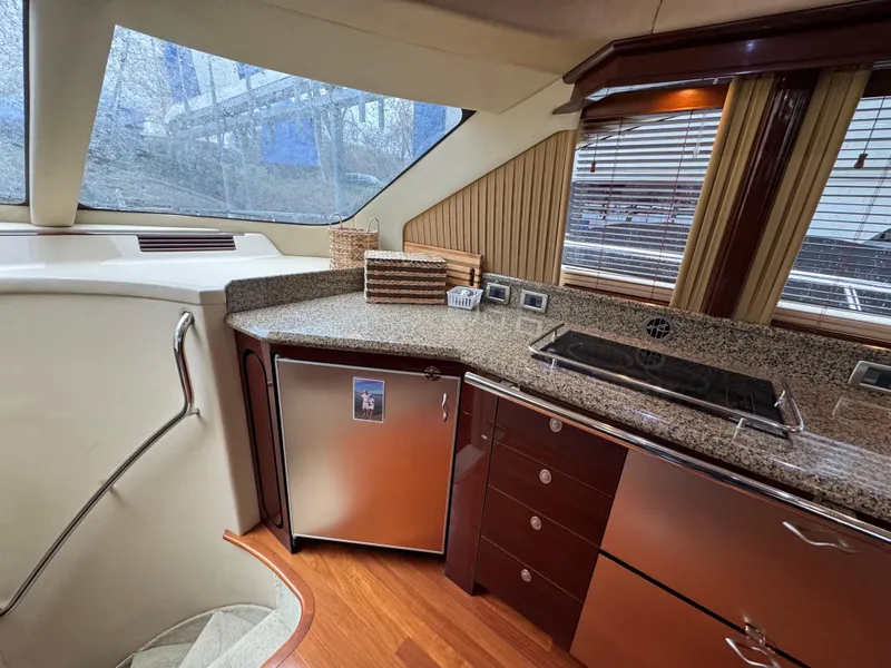 Slide: The Image of Luxurious 2007 Sea Ray 58 Sedan Bridge yacht kitchen with modern appliances and elegant wood finishes. - 47