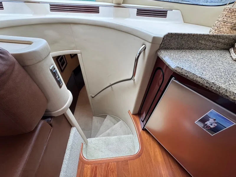 Slide: The Image of Interior of 2007 Sea Ray 58 Sedan Bridge yacht with stairs and compact kitchen area. - 48