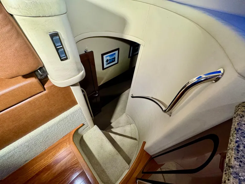 Slide: The Image of Staircase inside 2007 Sea Ray 58 Sedan Bridge yacht with elegant design and wooden flooring. - 49