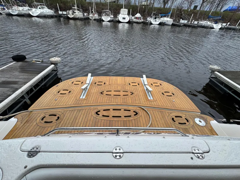 Slide: The Image of 2007 Sea Ray 58 Sedan Bridge yacht docked with wooden deck view. - 5