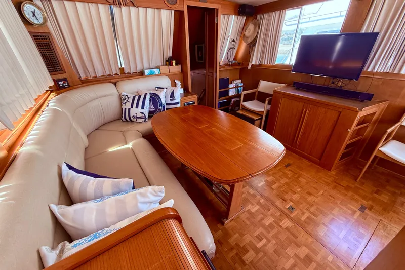 Slide: The Image of Luxurious 1992 Grand Banks 46 Classic yacht interior with elegant seating and wooden table. - 13