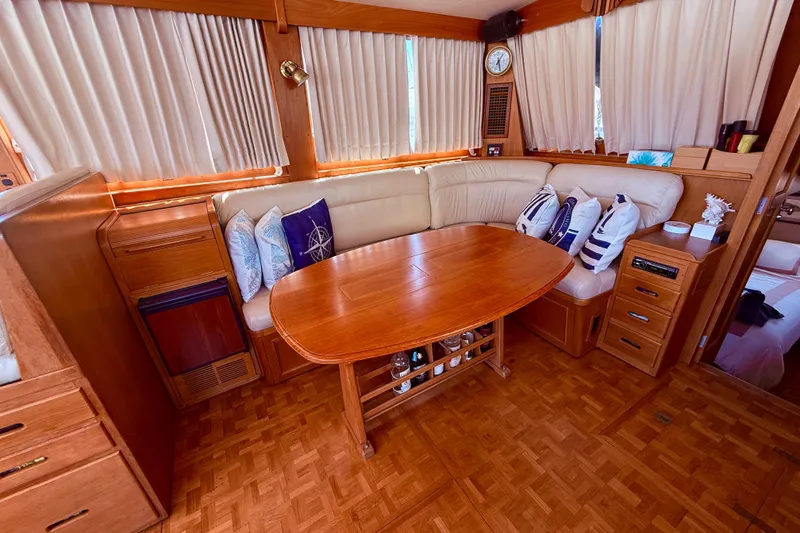 Slide: The Image of Interior of 1992 Grand Banks 46 Classic yacht with wooden table and cushioned seating. - 15