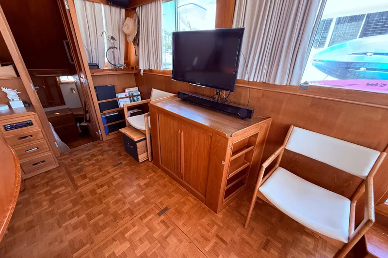 Slide: The Image of Interior of 1992 Grand Banks 46 Classic yacht with wooden furnishings and a mounted TV. - 16