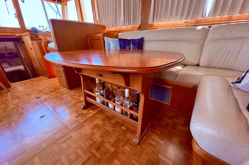Slide: The Image of Interior of 1992 Grand Banks 46 Classic yacht with wooden table and beige seating. - 19
