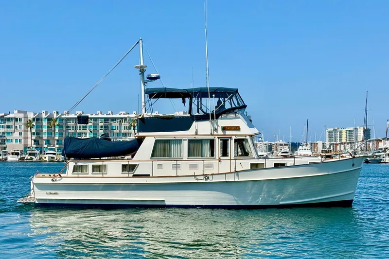 Slide: The Image of Grand Banks 46 Classic 1992 yacht docked in marina, clear blue sky background. - 2