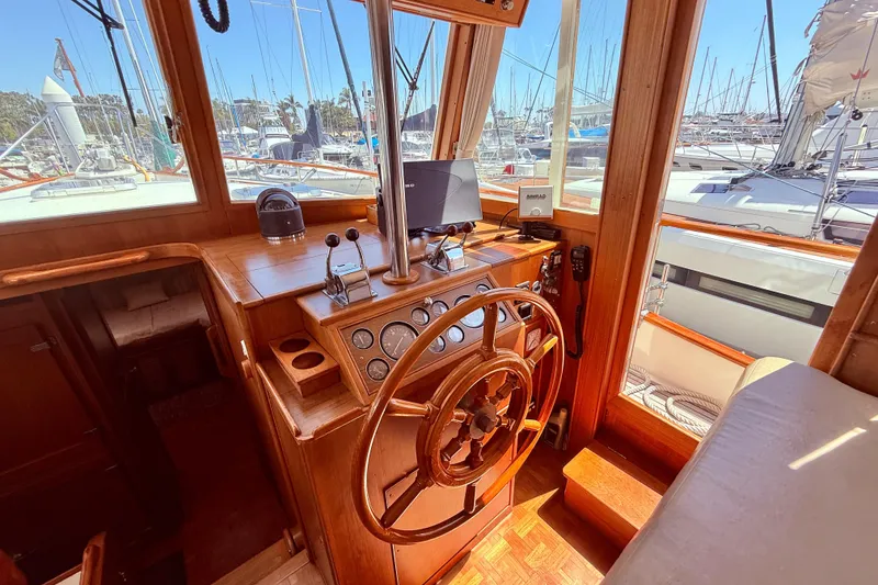 Slide: The Image of Helm of 1992 Grand Banks 46 Classic yacht with wooden steering wheel and navigation equipment. - 23