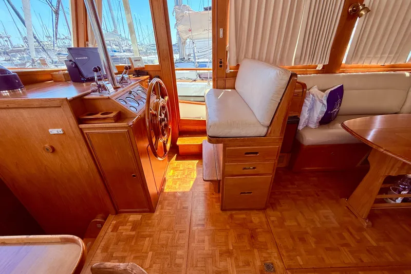 Slide: The Image of Interior of 1992 Grand Banks 46 Classic yacht with wooden helm and seating area. - 24