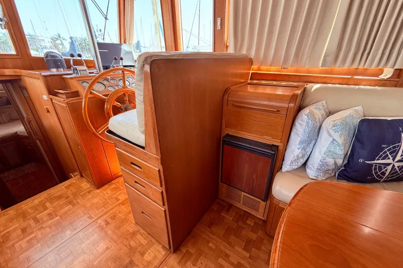 Slide: The Image of Interior of a 1992 Grand Banks 46 Classic yacht with wooden helm and seating area. - 25