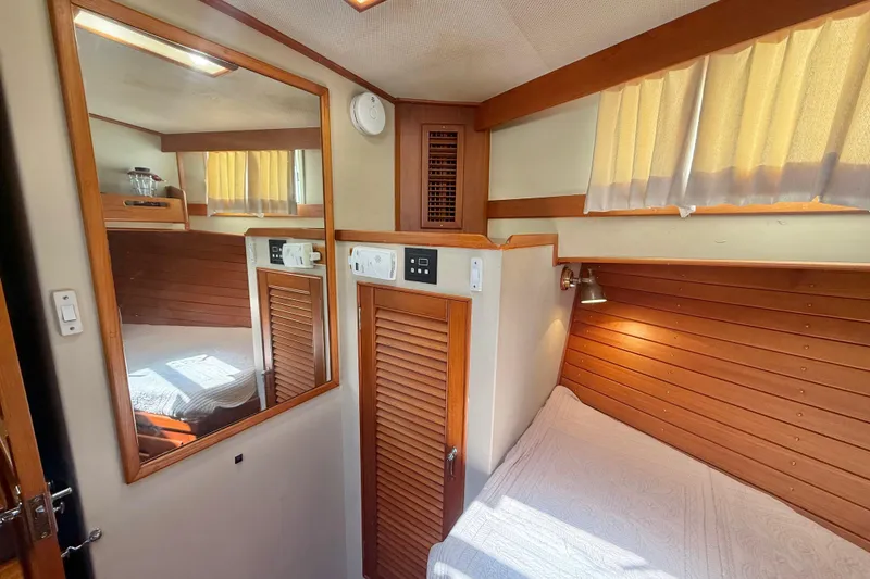 Slide: The Image of Cozy cabin interior of 1992 Grand Banks 46 Classic yacht with wood paneling and soft lighting. - 32