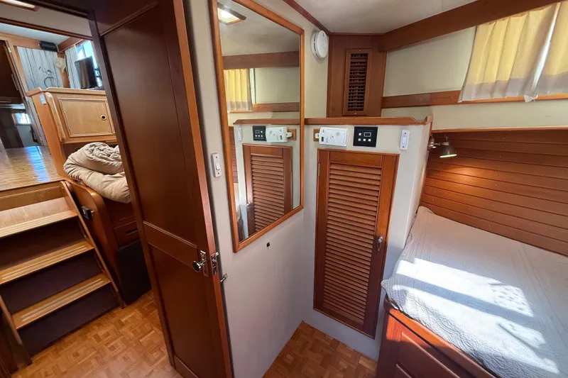 Slide: The Image of Interior of 1992 Grand Banks 46 Classic yacht with wood paneling and cozy sleeping area. - 33