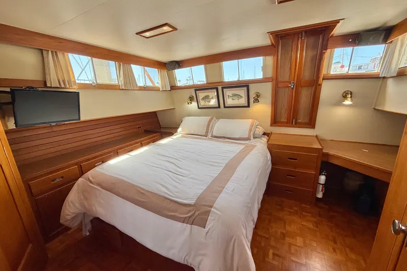 Slide: The Image of Luxurious cabin interior of 1992 Grand Banks 46 Classic yacht with cozy bed and wooden furnishings. - 39