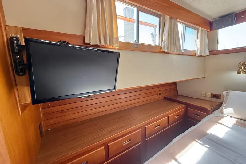 Slide: The Image of Interior of 1992 Grand Banks 46 Classic yacht with TV and wooden cabinetry. - 42