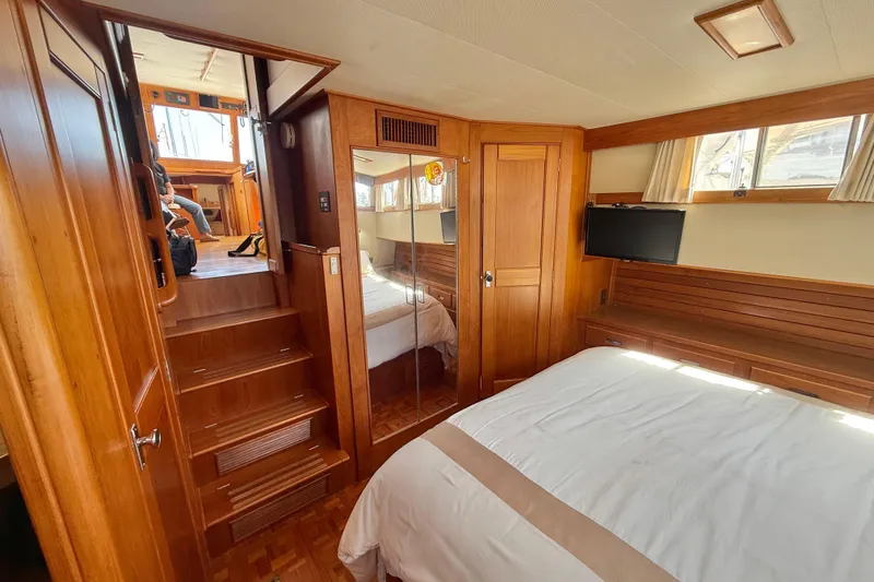 Slide: The Image of Interior of 1992 Grand Banks 46 Classic yacht with wooden furnishings and cozy bedroom. - 45