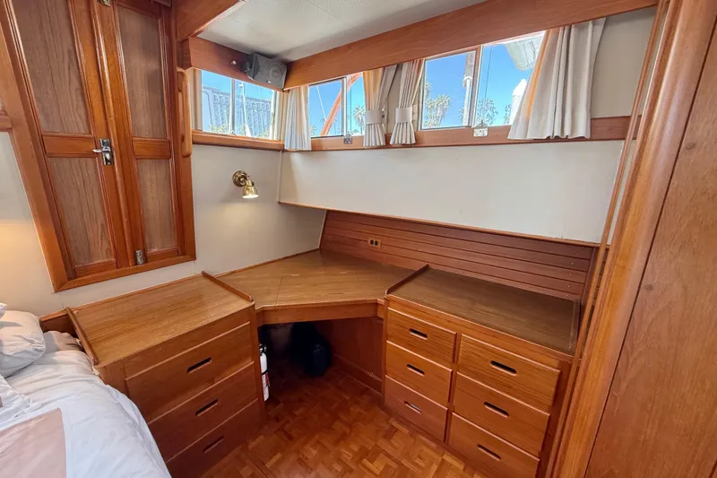 Slide: The Image of Interior of 1992 Grand Banks 46 Classic yacht with wooden cabinetry and desk area. - 48