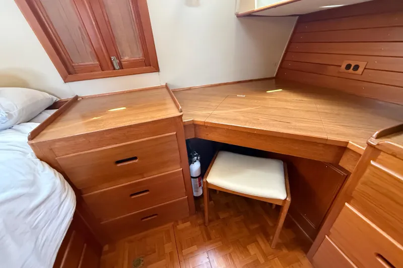 Slide: The Image of Wooden desk and drawers in a 1992 Grand Banks 46 Classic yacht interior. - 49