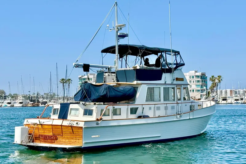 Slide: The Image of Grand Banks 46 Classic yacht from 1992 on calm waters, marina background. - 5