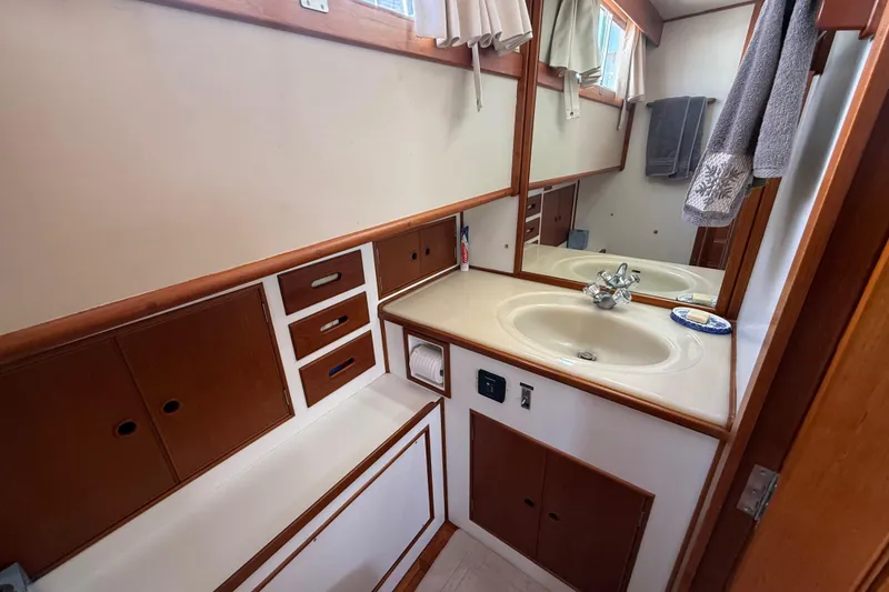 Slide: The Image of Bathroom interior of 1992 Grand Banks 46 Classic yacht with wooden cabinetry and sink. - 50