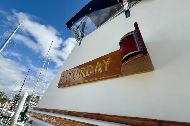 Slide: The Image of 1992 Grand Banks 46 Classic boat with "Saturday" nameplate, docked under a blue sky. - 51