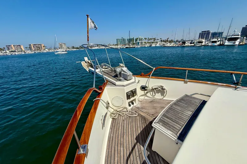 Slide: The Image of Grand Banks 46 Classic yacht deck, 1992 model, overlooking marina with clear blue skies. - 53