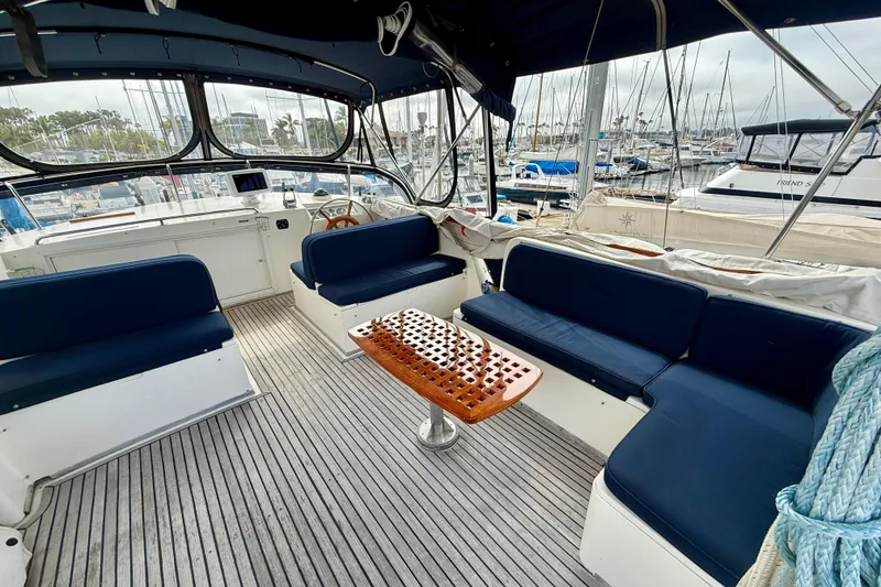 Slide: The Image of Spacious cockpit of 1992 Grand Banks 46 Classic yacht with blue seating and wooden table. - 57