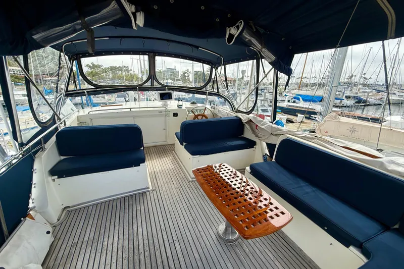 Slide: The Image of Spacious cockpit of 1992 Grand Banks 46 Classic yacht with blue seating and wooden table. - 58