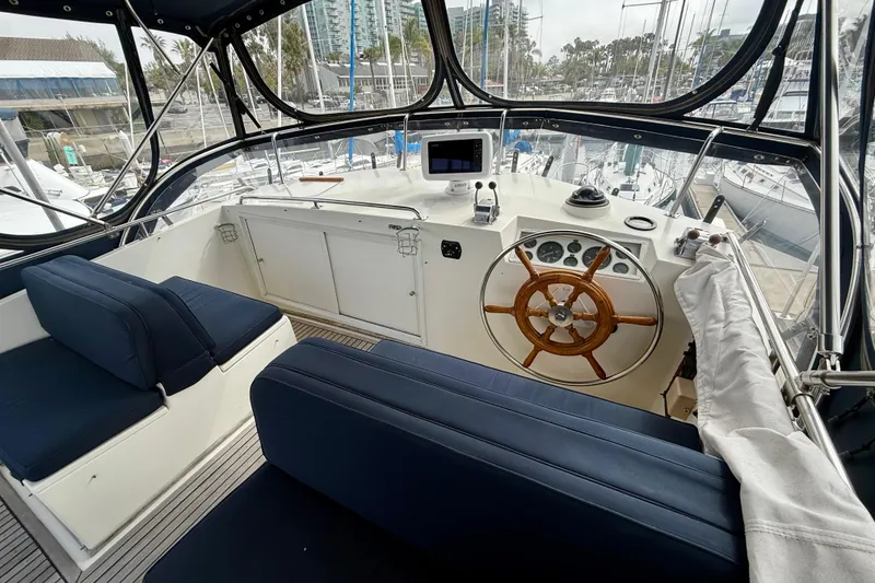 Slide: The Image of Helm of 1992 Grand Banks 46 Classic yacht with wooden wheel and navigation equipment. - 61